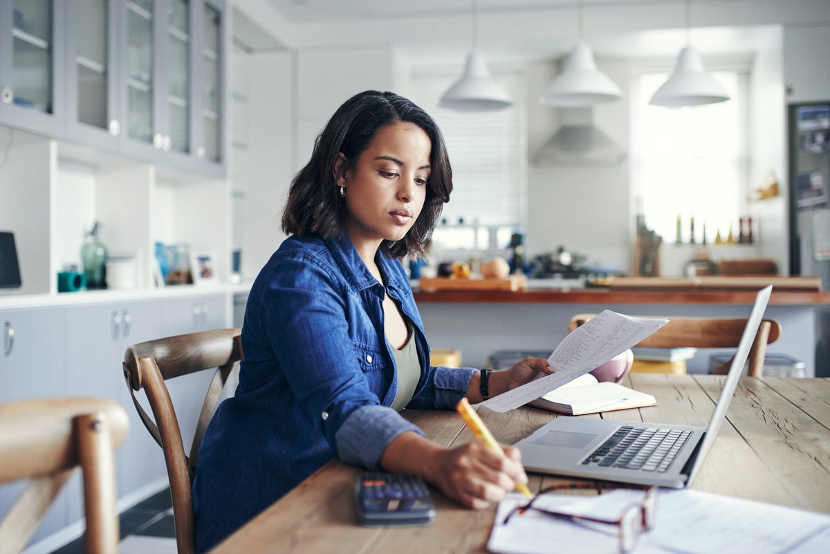 woman at desk with paperwork