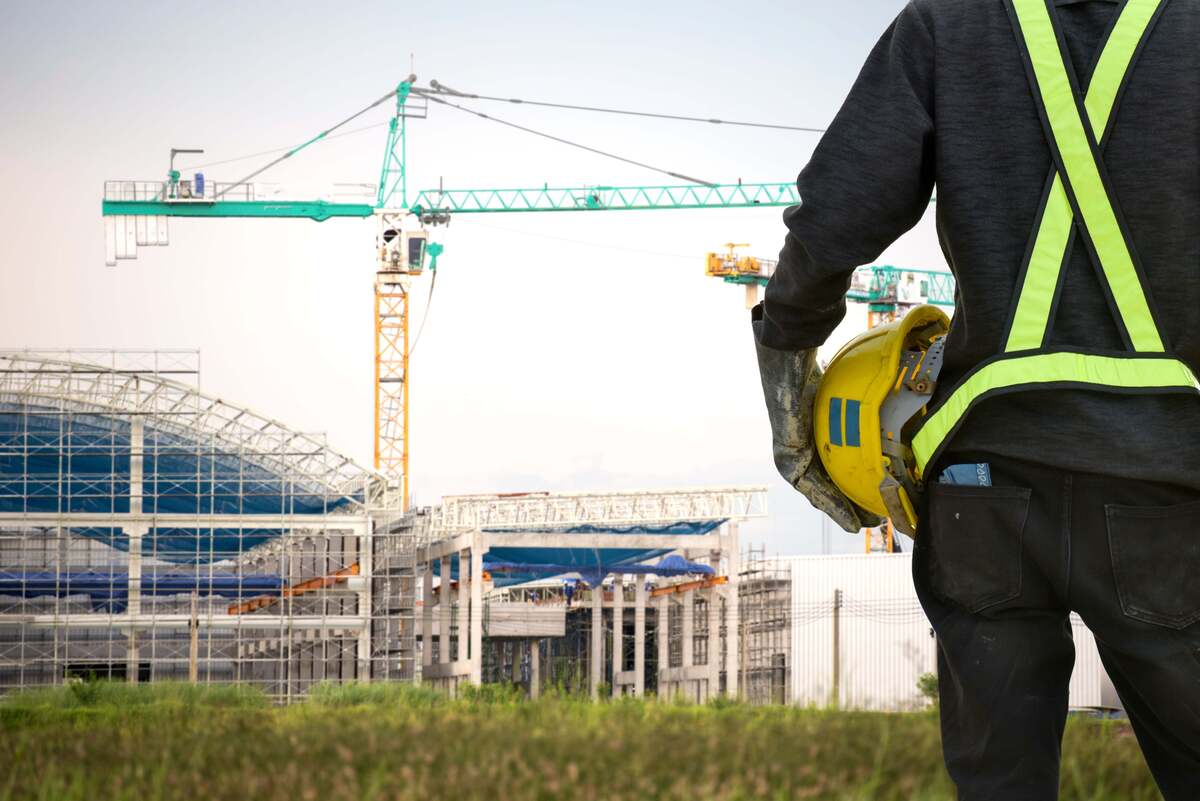 building construction site / contractor / engineer / hard hat / crane