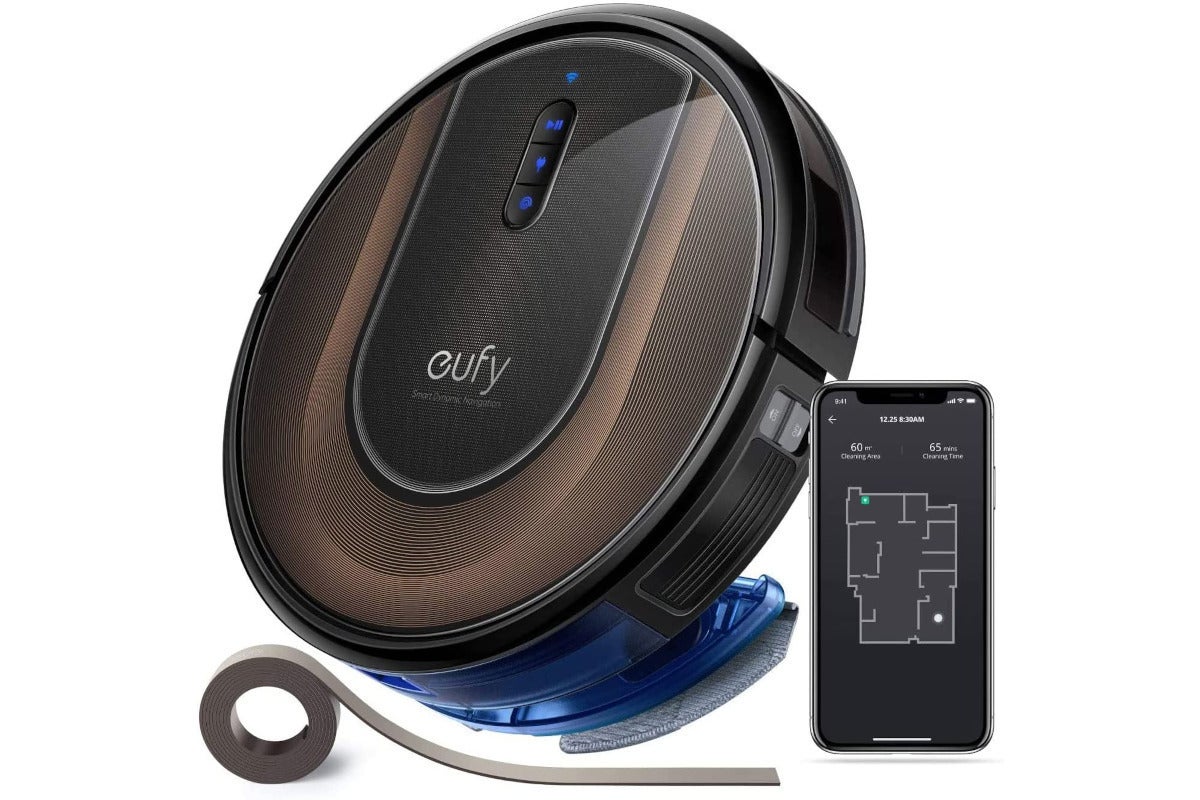 a brown robot vacuum with a smartphone and a roll of boundary strip