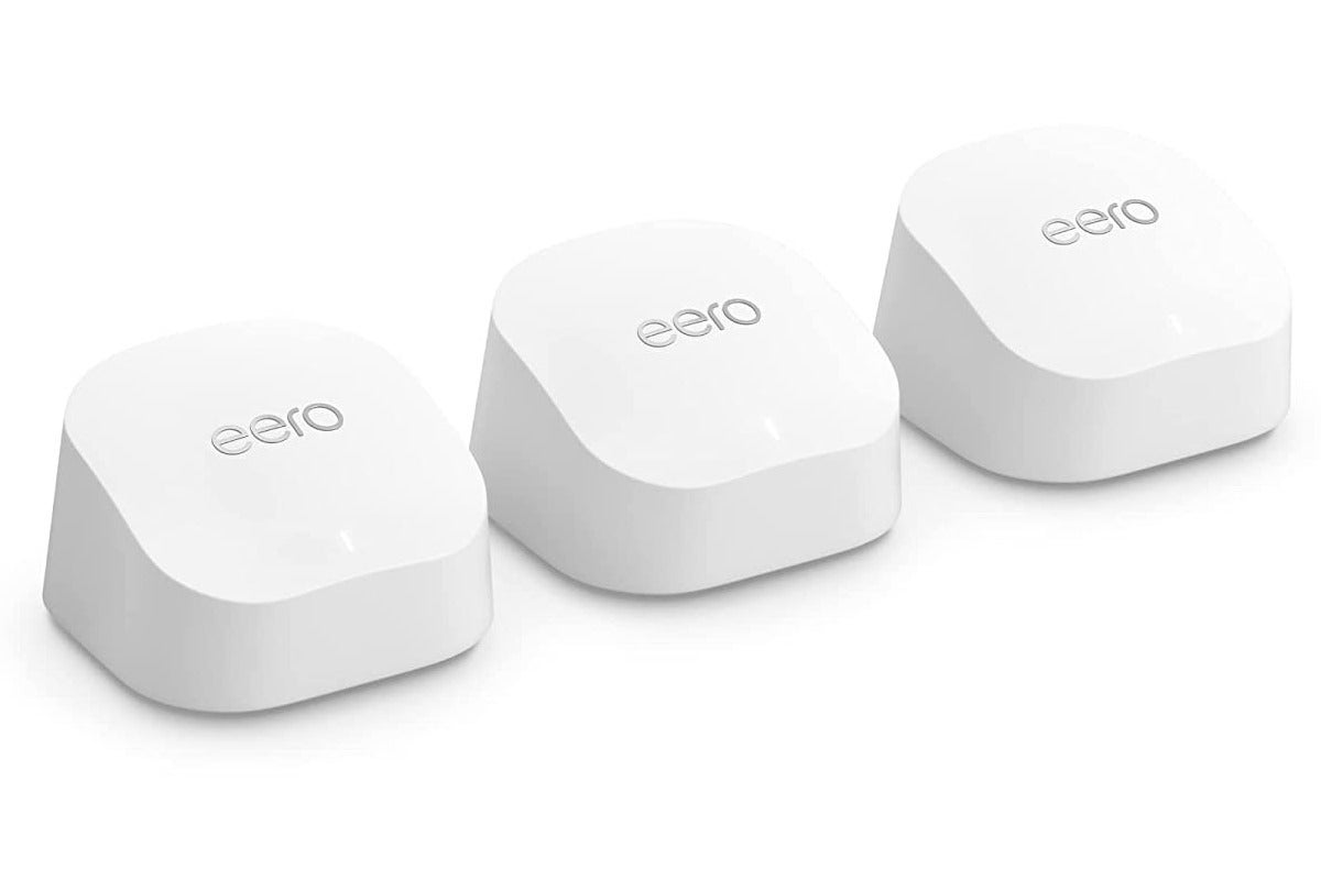 Three white Eero routers lined up from left to right