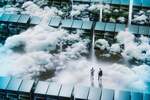Two figures within a data center / server maze, strewn with clouds.