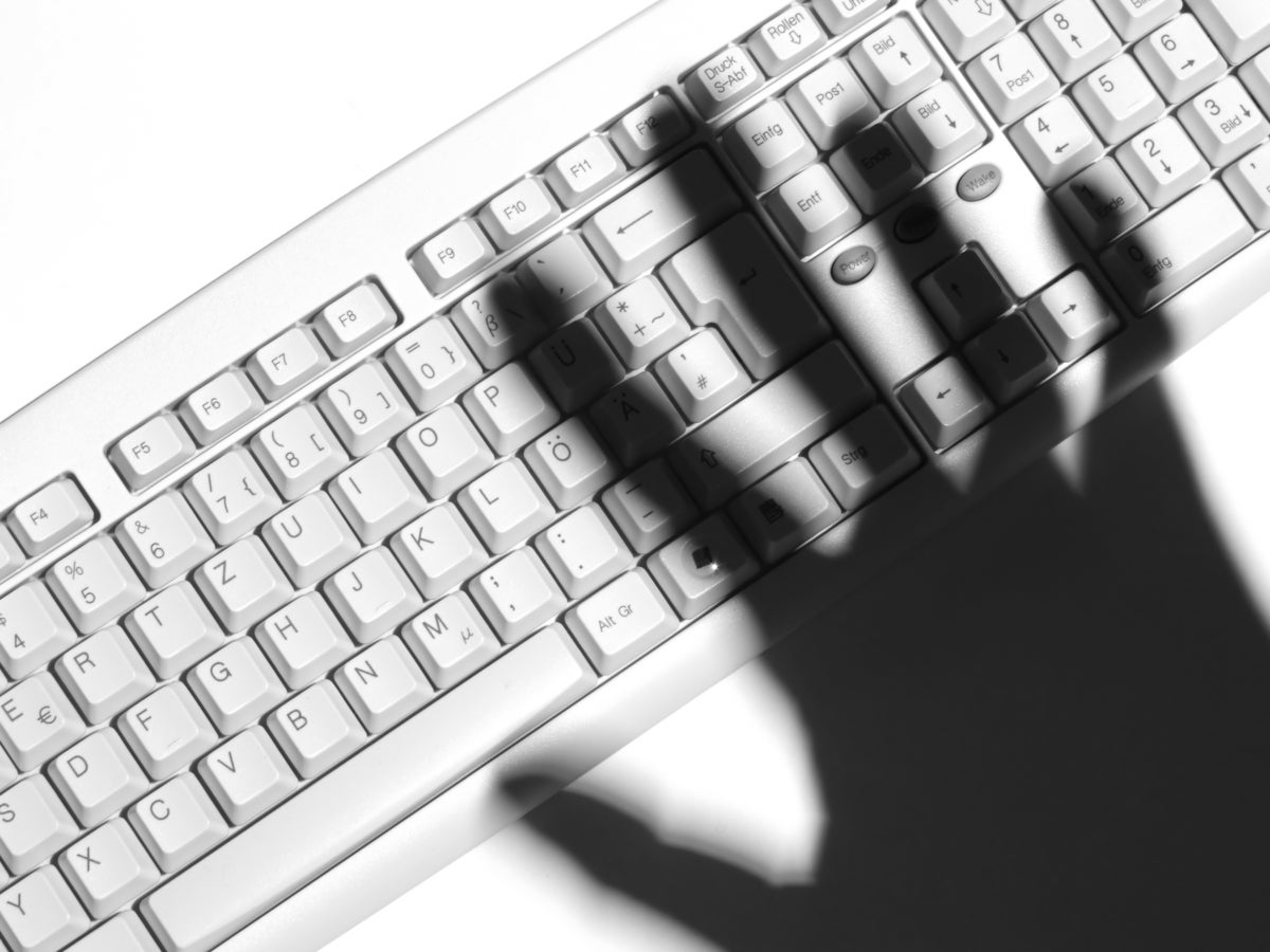 shadow of a hand over keyboard